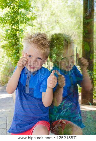 Beautiful little boy smiling next to a window
