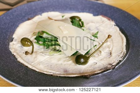 Italian dish Vitello Tonnato pieces of marinated beef, seasoned tuna cream sauce