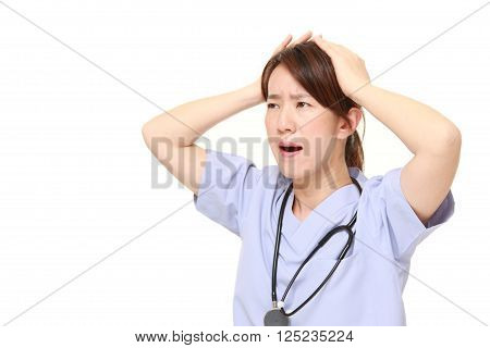portrait of  Japanese female doctor shocked  on white background