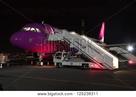 Kiev Ukraine - March 27 2011: Wizz Air Airbus A320 passenger plane being serviced at the airport at night