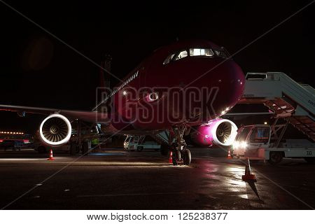 Kiev Ukraine - March 27 2011: Wizz Air Airbus A320 plane waiting for the passengers at the airport at night