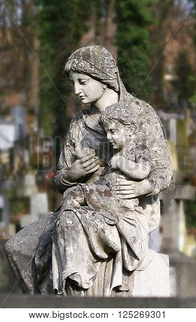 statue of a woman with a child on the grave Lychakiv memorial cemetery Lviv Ukraine