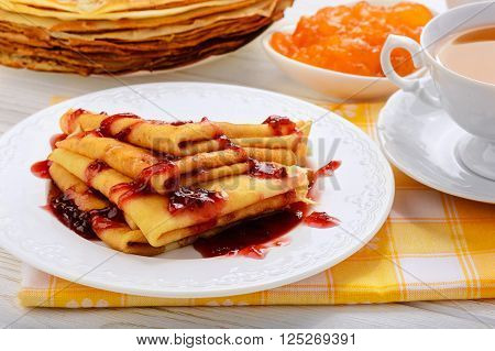 Pancakes with jam and cup of tea.