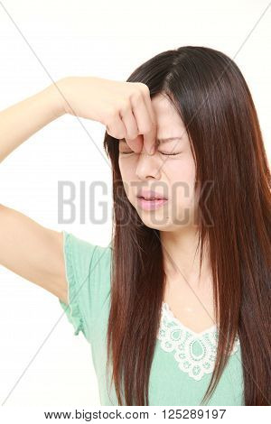 portrait of young Japanese woman suffers from Asthenopia