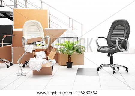 Move concept. Unpacking cardboard boxes in a new office