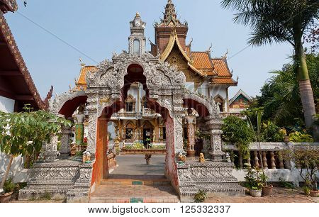 Carved gate to ancient Buddhist temple structure of Wat Buppharam in Chiang Mai Thailand. Historical importance temple was established in 1497 by King Muang Kaew