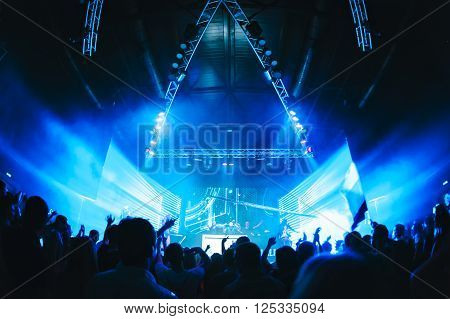 night party festival crowd of people silhouettes hands up