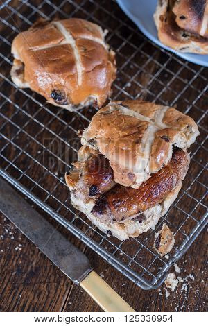 Three Cross Buns On A Cooling Rack By A Knife