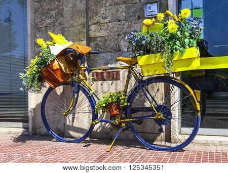 beautiful floral street decoration with old bisycle of postman