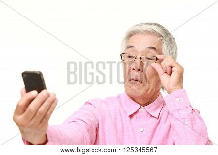 portrait of senior Japanese man with presbyopia