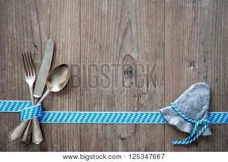 Bavarian cutlery on wooden table with copy space. Oktoberfest beer festival background. Menu for Bavarian specialties