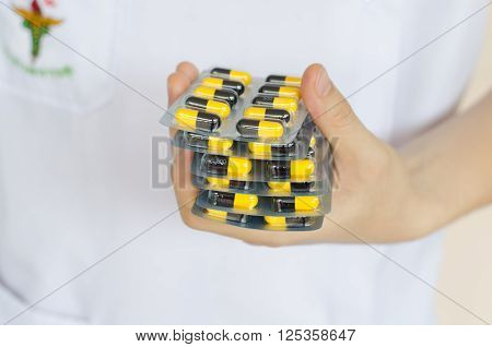 Antibiotic drugs in hands. Health care concept.
** Note: Shallow depth of field