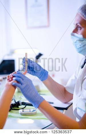Measure child glucose level blood test diabetes little girl using glucometer selective focus