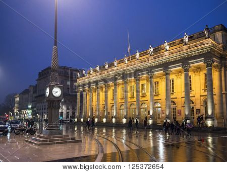 Bordeaux France - March 25 2016. People walking in front of Grand Theatre de Bordeaux at night. The theatre is home to the Opera National de Bordeaux and the Ballet National de Bordeaux. Bordeaux Aquitaine. France.