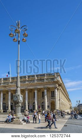 Bordeaux France - March 26 2016. People walking in front of Grand Theatre de Bordeaux at sunny day. The theatre is home to the Opera National de Bordeaux and the Ballet National de Bordeaux. Bordeaux Aquitaine. France.