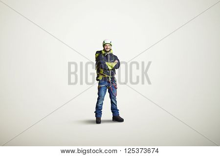 Man wear winter clothes, hard-hat, bag and crossed his hands, on white background