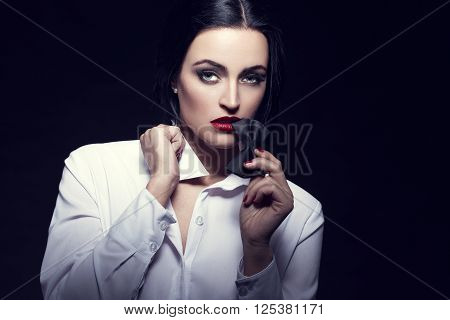 Sexyl woman bite tux at night sensuality and desire