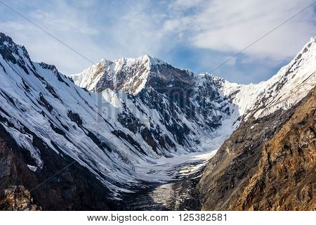 Aerial View of High Altitude Snowbound Mountains with Massive Glaciers Sharp Rock Ridges and Ice Slopes