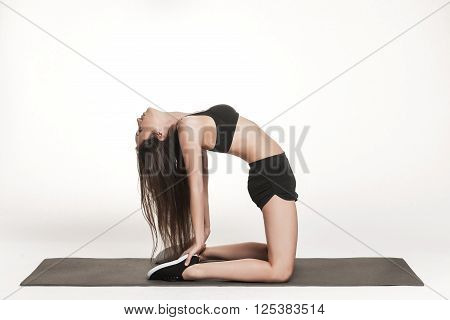Portrait of young attractive woman doing exercises. Brunette with fit body on yoga mat. Healthy lifestyle and sports concept. Series of exercise poses.