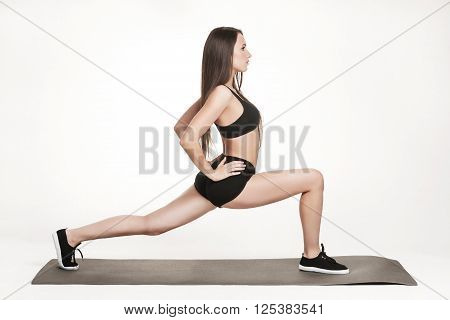 Portrait of young attractive woman doing exercises. Brunette with fit body on yoga mat. Healthy lifestyle and sports concept. Series of exercise poses.