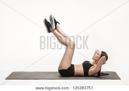 Portrait of young attractive woman doing exercises. Brunette with fit body on yoga mat. Healthy lifestyle and sports concept. Series of exercise poses.