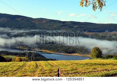 cold morning fog in an autumn landscape norway
