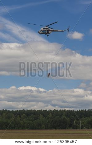 Minsk Belarus-June 21 2014: Staff of Ministry of Emergency Situations Performing Air Elements on MI-2 Helicopter During Aviation Sport Event Dedicated to the 80th Anniversary of DOSAAF Foundation in Minsk on June 21 2014 in Minsk Republic of Belarus