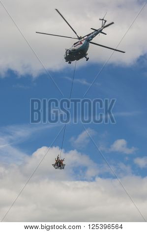 Minsk Belarus-June 21 2014: Staff of Ministry of Emergency Situations Performing Air Elements on MI-8MT Helicopter During Aviation Sport Event Dedicated to the 80th Anniversary of DOSAAF Foundation in Minsk on June 21 2014 in Minsk Republic of Belarus