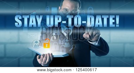 Corporate end user is pressing STAY UP-TO-DATE! on a virtual touch screen interface. Business challenge metaphor and information technology concept for keeping your IT knowledge and software current.