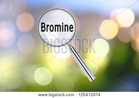 Magnifying lens over background with text Bromine, with the blurred lights visible in the background. 3D rendering