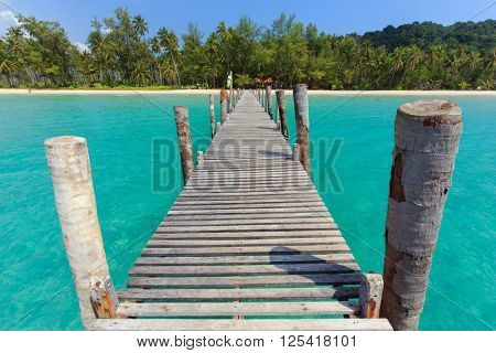 Wooden pontoon in the turquoise tropical sea of Bang Bao Bay in Ko Kood island, Thailand . 