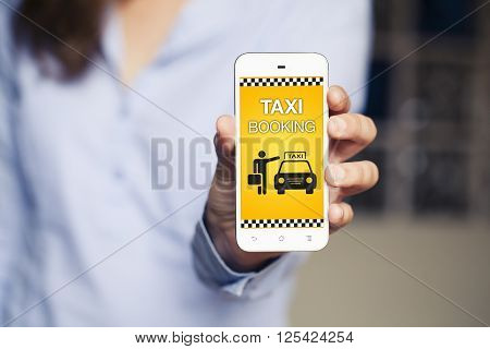 Taxi booking app on a mobile phone held by woman hand.