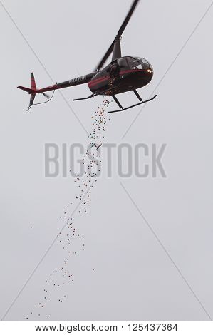 MARIETTA, GA - MARCH 2016: Someone drops plastic Easter eggs from a helicopter onto a local high school football field for a community Easter egg hunt in Marietta GA on March 26 2016 .