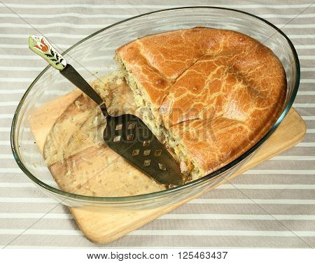 Fish pie in clear glass baking dish with beautiful distributing blade.