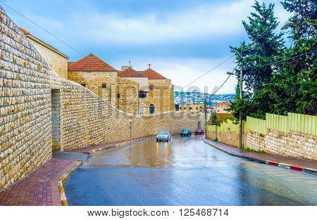 Rainy El-Wadi El-Jawani road with Carmelite monastery of Nazaret Israel.
