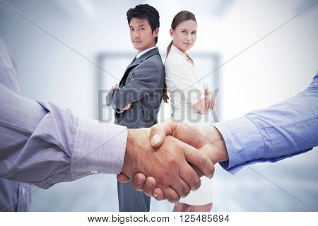 Composite image of men shaking hands