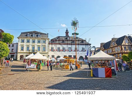 LINZ AM RHEIN GERMANY - MAY 4 2013: City Hall and Street market on Marktplatz in Linz am Rhein in Rhineland-Palatinate in Germany. Square in the City center. Tourists around.