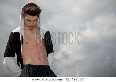 Teenage boy showing off his abdominal muscles