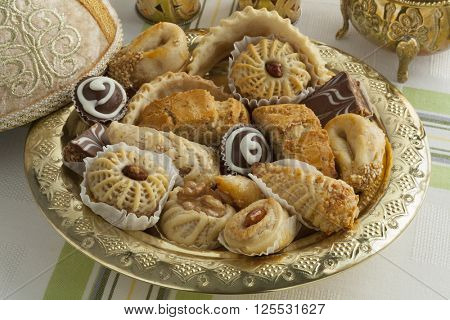 Traditional Moroccan festive cookies on a metal tajine 