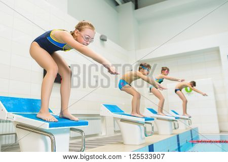 children ready to jump into sport swimming pool. Sporty kids.