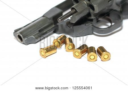 Photo of black revolver gun with cartridges isolated on white background