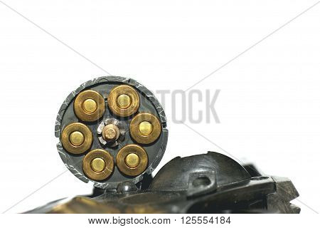 Photo of black revolver gun with cartridges isolated on white background