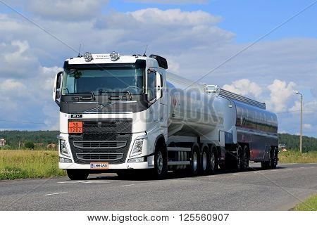 SALO, FINLAND - JULY 17, 2015: White Volvo FH tank truck in ARD haul along urban road at summer. The ADr code 30-1202 stands for diesel fuel.