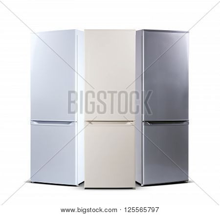 Three refrigerators. White, beige, grey metallic isolated on white