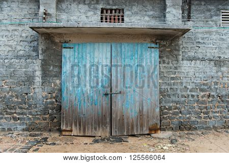 wall of ancient wooden barn with door