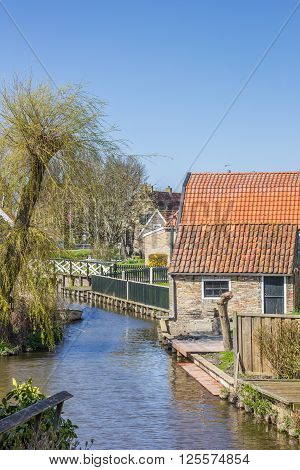Little canal in the historical city Hindeloopen Netherlands