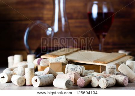 Background with glass of wine decanter and wine corcs. Wine concept