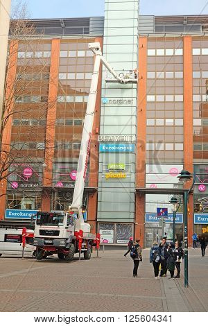 Helsinki, Finland - April, 4, 2016: workers is engaged in restoration of the modern multi-storey building in Helsinki, Finland