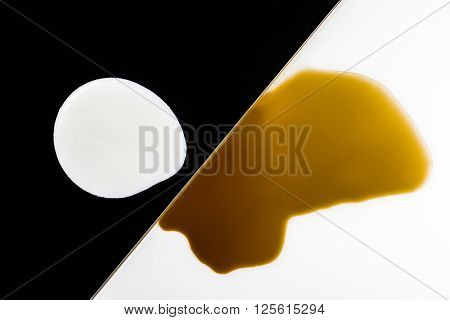 brown and white coffee and milk blots on white and black background