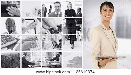 Businesswoman holding tablet pc against modern room overlooking city
